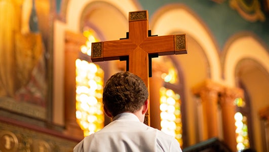 A cross is carried during a church service