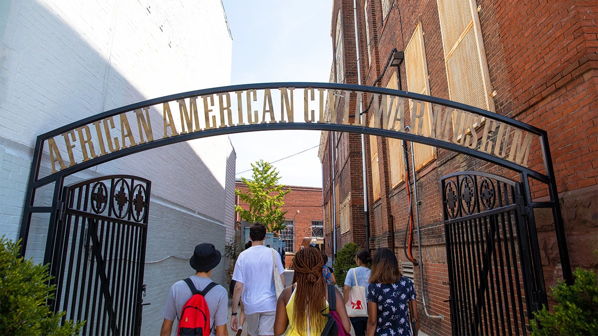 Students walk into the front gate of the African American Civil War Museum